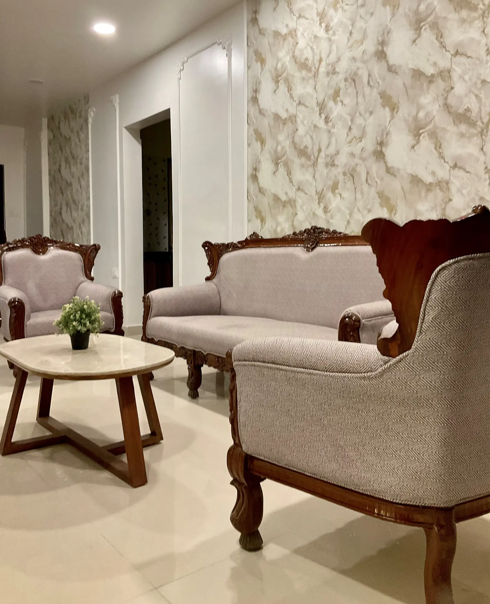 Living room with classic furniture and marble wall